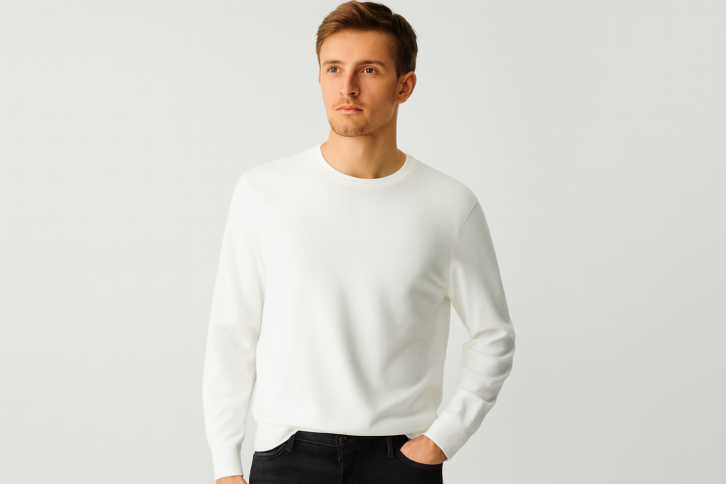 Caucasian model in white crewneck sweater and black jeans