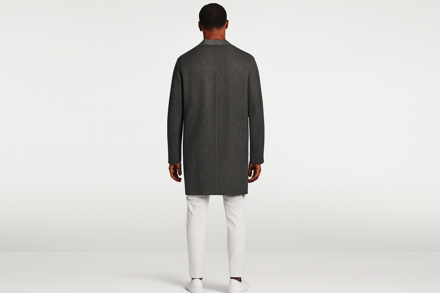 Model back view in white outfit with charcoal jacket