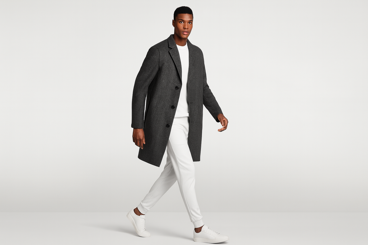 Model in white outfit with charcoal blazer