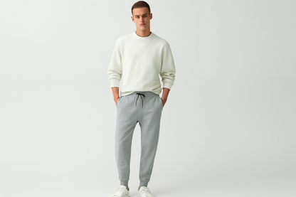 Caucasian model in melange grey joggers with white top