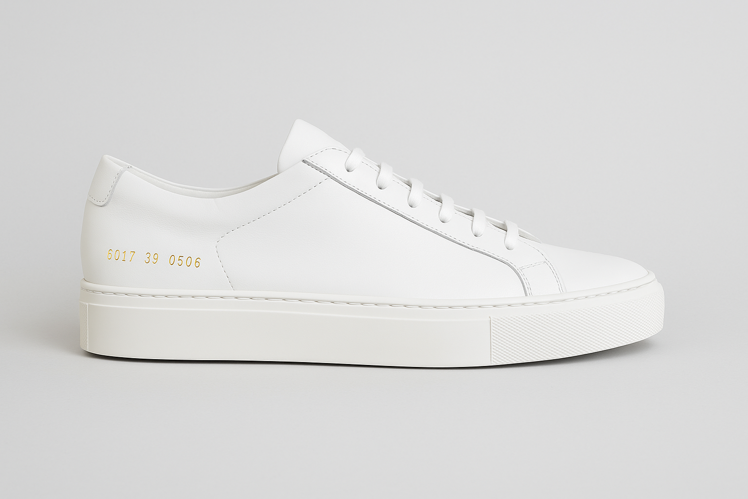 Clean side view of Common Projects Tournament sneakers