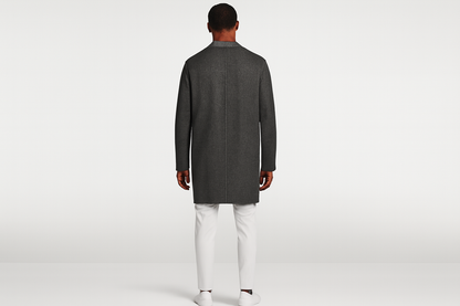 Model back view in white outfit with charcoal jacket